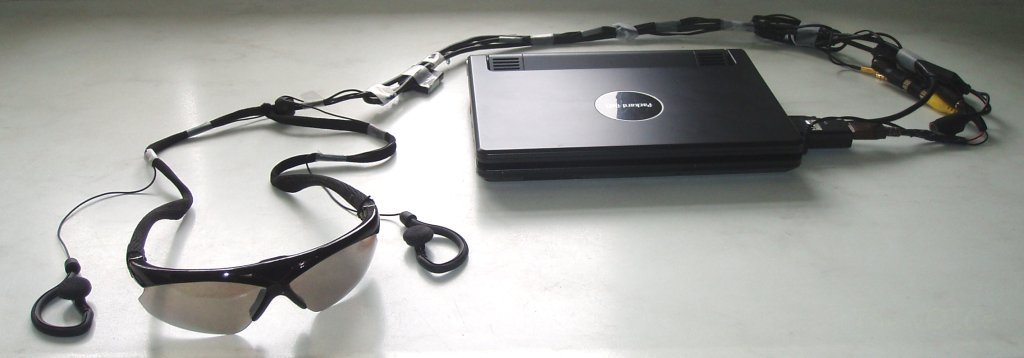 The vOICe wearable setup: netbook, USB capture device, USB DC-DC converter, video sunglasses and earbuds